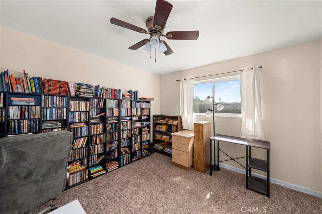 12610 Serrano Drive Yucaipa, CA 92399 - Photo 12 of 29 a view of a livingroom with workspace and a ceiling fan
