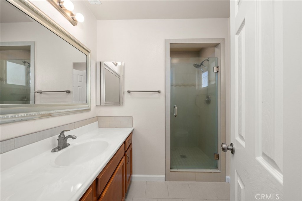 12610 Serrano Drive Yucaipa, CA 92399 - Photo 17 of 29 a bathroom with a sink and a mirror