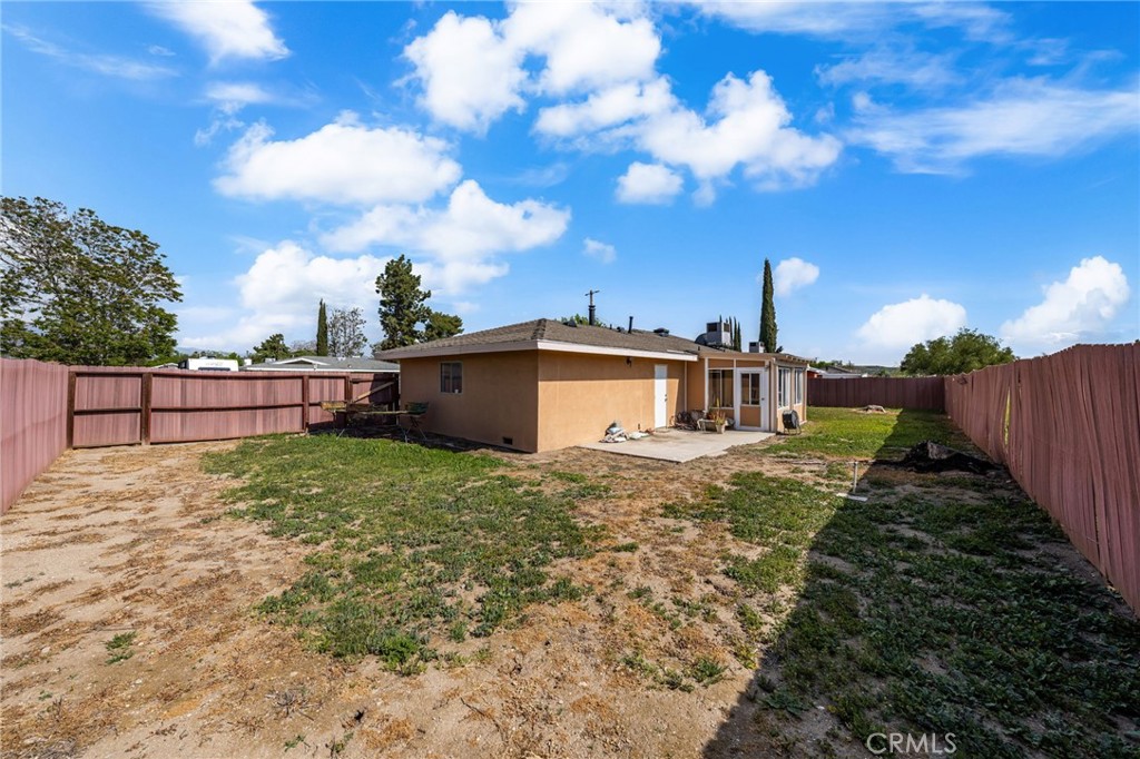 12610 Serrano Drive Yucaipa, CA 92399 - Photo 20 of 29 a view of a house with a yard