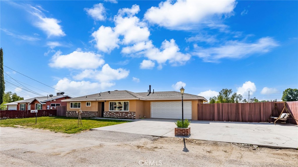 12610 Serrano Drive Yucaipa, CA 92399 - Photo 2 of 29 a front view of a house with a yard