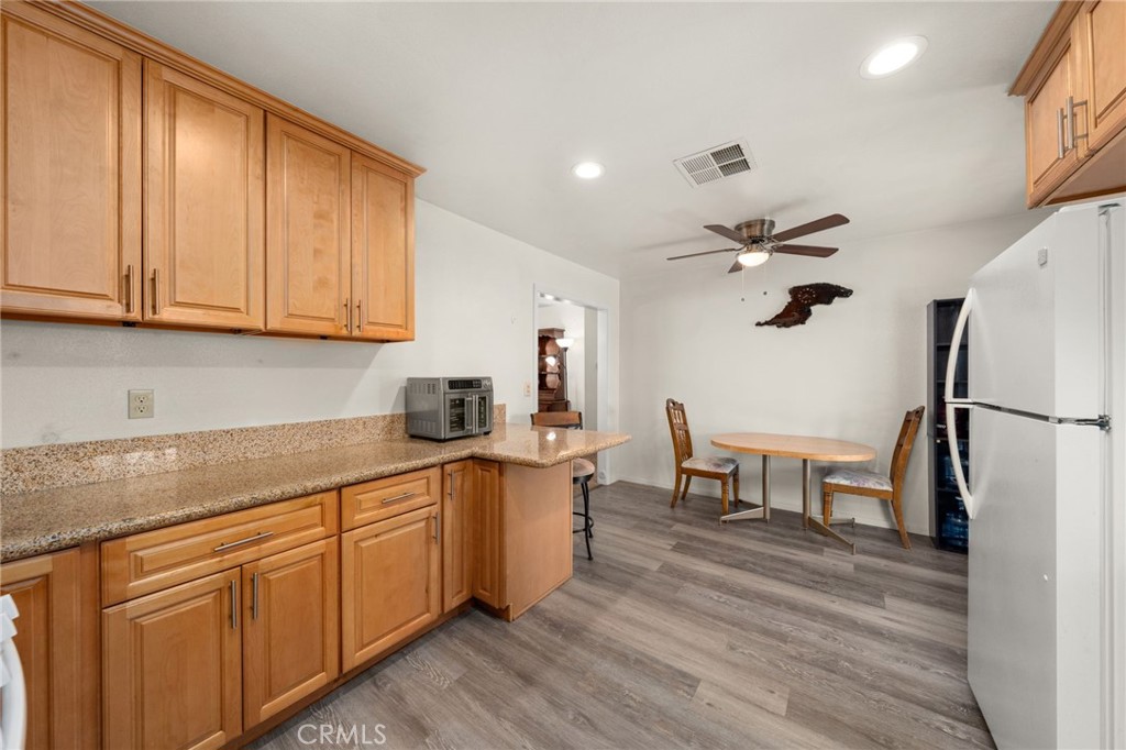 12610 Serrano Drive Yucaipa, CA 92399 - Photo 8 of 29 a kitchen with a sink cabinets and wooden floor