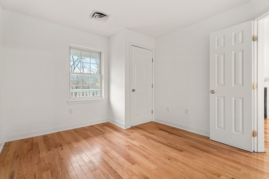 100 Brookside Drive, Unit F Andover, MA 01810 - Photo 11 of 22 a view of empty room with wooden floor and fan