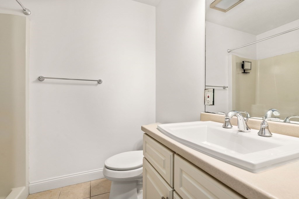 100 Brookside Drive, Unit F Andover, MA 01810 - Photo 19 of 22 a bathroom with a sink toilet and vanity