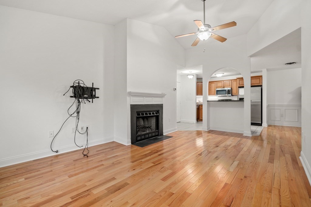 100 Brookside Drive, Unit F Andover, MA 01810 - Photo 4 of 22 a view of a room with a ceiling fan hardwood floor a ceiling fan and a kitchen