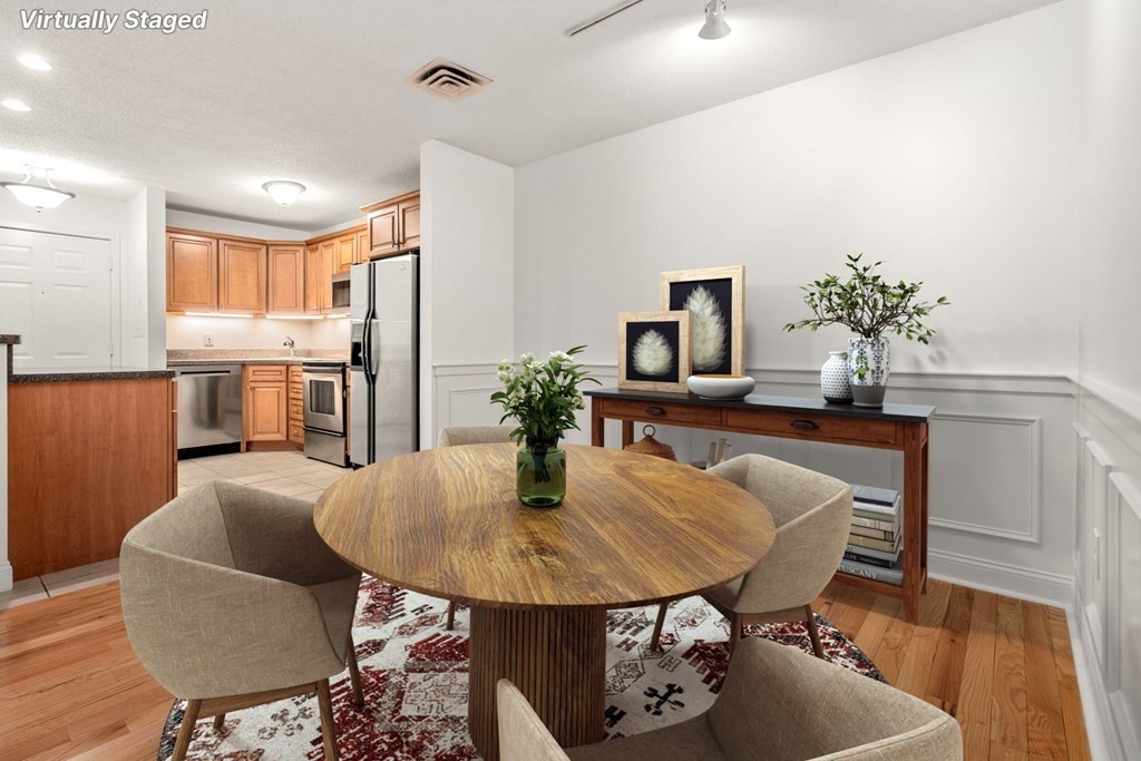 100 Brookside Drive, Unit F Andover, MA 01810 - Photo 7 of 22 a kitchen with a table and chairs in it