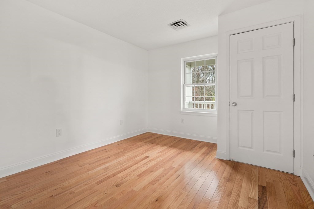 100 Brookside Drive, Unit F Andover, MA 01810 - Photo 10 of 22 a view of an empty room with wooden floor and a window