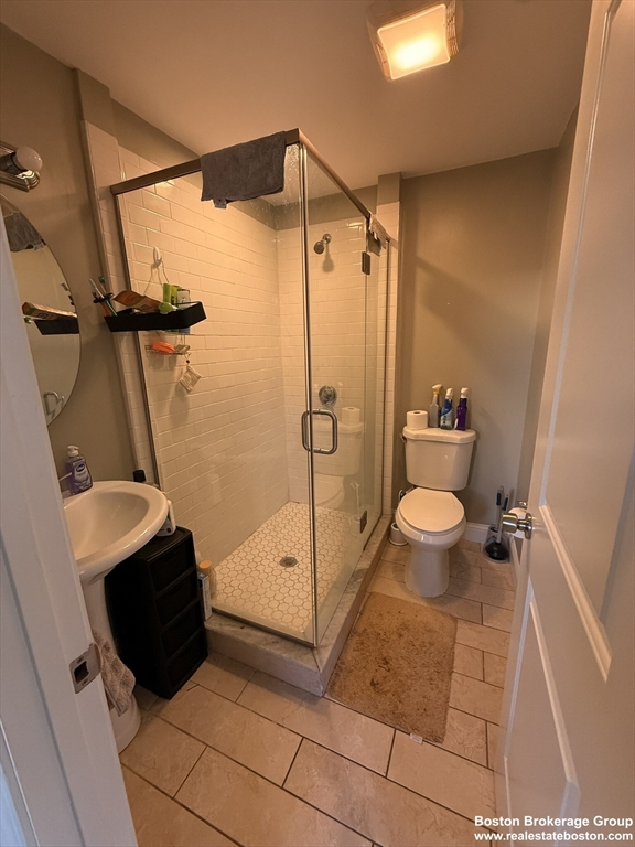 10 Roxbury Street, Unit 3 Boston, MA 02119 - Photo 11 of 11 a bathroom with a shower and a toilet