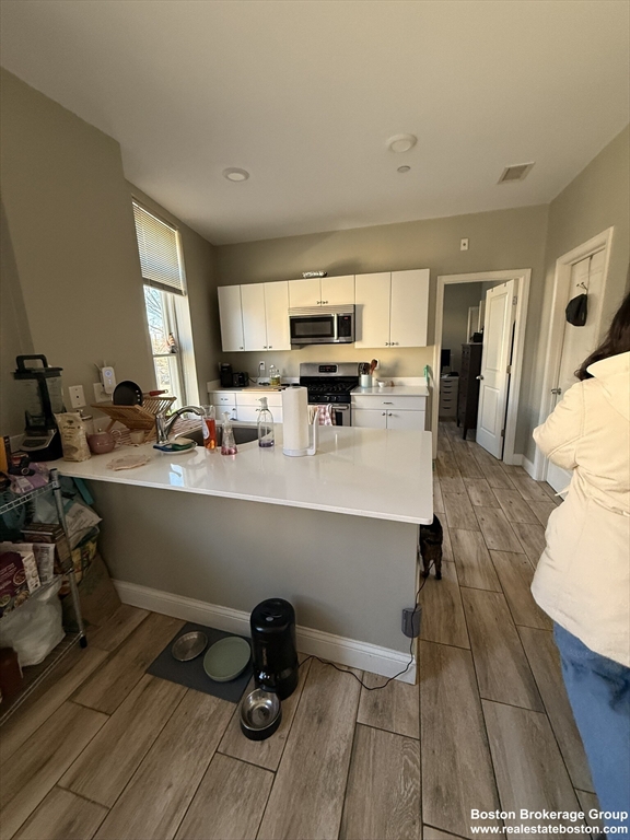 10 Roxbury Street, Unit 3 Boston, MA 02119 - Photo 2 of 11 a room with a sink and a mirror