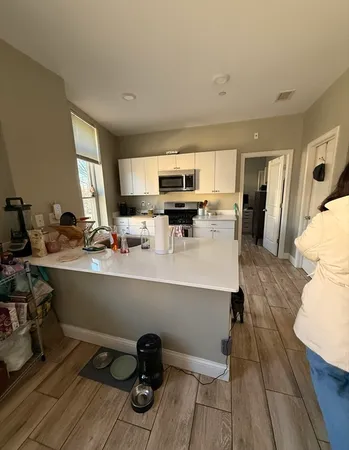 a kitchen with a sink appliances and cabinets