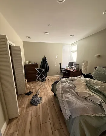 a bed room with a bed and a rug
