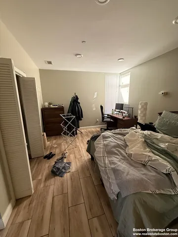 a bed room with a bed furniture and a wooden floor