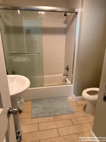 a bathroom with a toilet and a shower