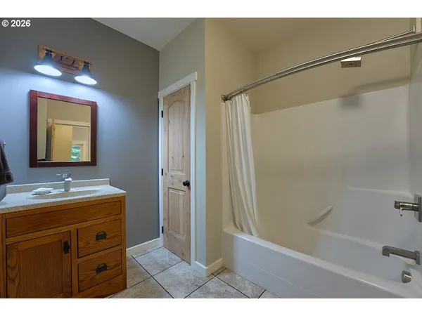 a bathroom with a sink a mirror and a shower