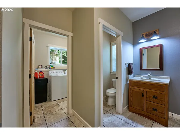 a bathroom with a toilet a sink a vanity and mirror