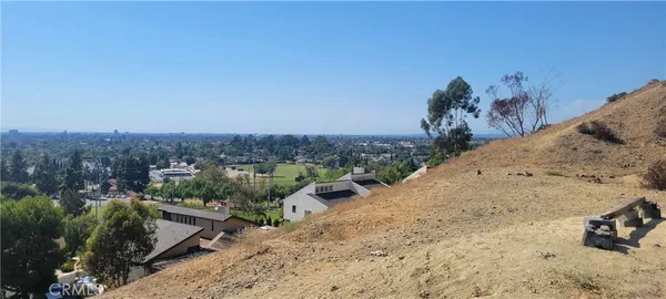 a kitchen with a sink a stove a refrigerator cabinets and a window