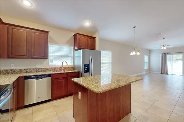 a kitchen with stainless steel appliances granite countertop a sink and a stove