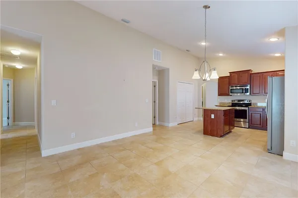 a kitchen with kitchen island a counter space cabinets and stainless steel appliances