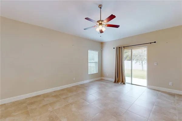 a view of a livingroom with a ceiling fan and window