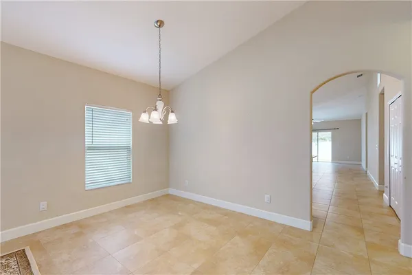 a view of a room with a chandelier fan and windows
