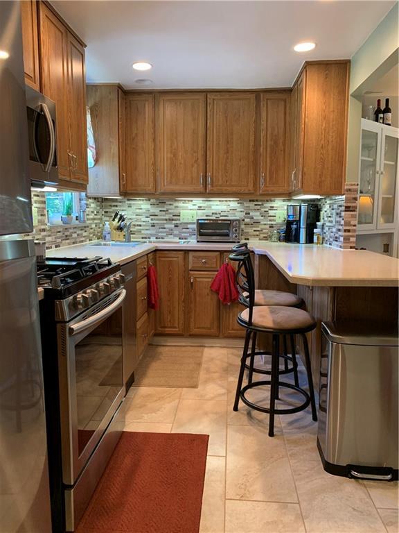 4305 Highgrove Road Pittsburgh, PA 15236 - Photo 11 of 24 Updated ceramic tile floor and Newer Stainless Steel Appliances! Did you see the additional seating under the counter?