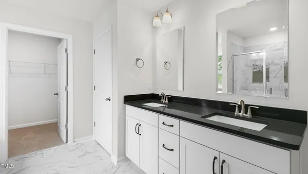 a bathroom with double sink and a mirror