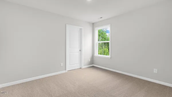 a bathroom with a granite countertop toilet sink and mirror