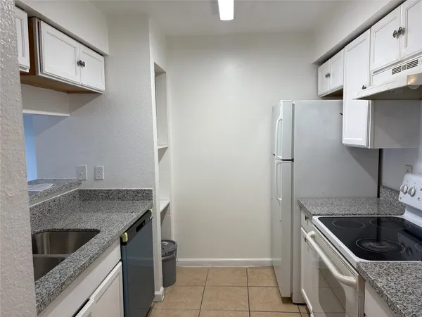 a kitchen with a sink stove and refrigerator