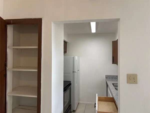 a view of hallway with cabinets