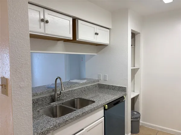 a kitchen with a sink and cabinets