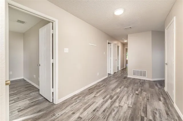 a view of hallway with wooden floor