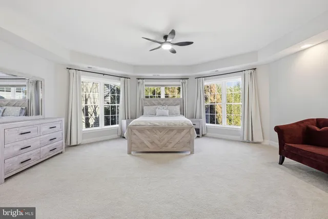 a spacious bedroom with a bed and a couch