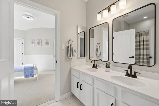 a bathroom with a double vanity sink mirror and double