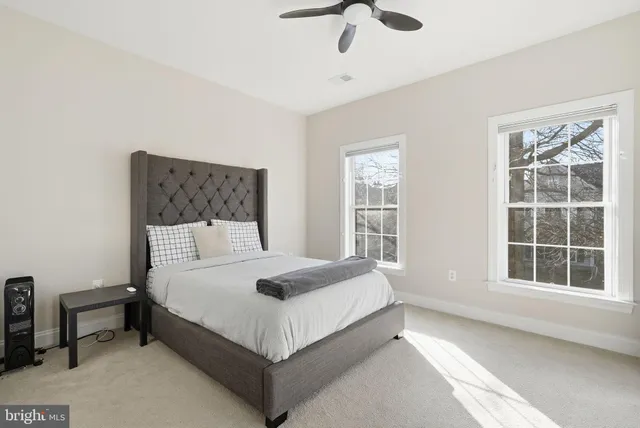 a bedroom with a large bed and a window