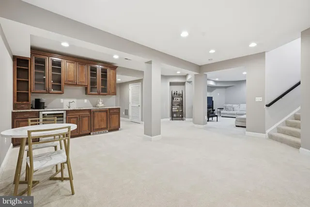 a view of kitchen with stainless steel appliances refrigerator stove microwave and cabinets
