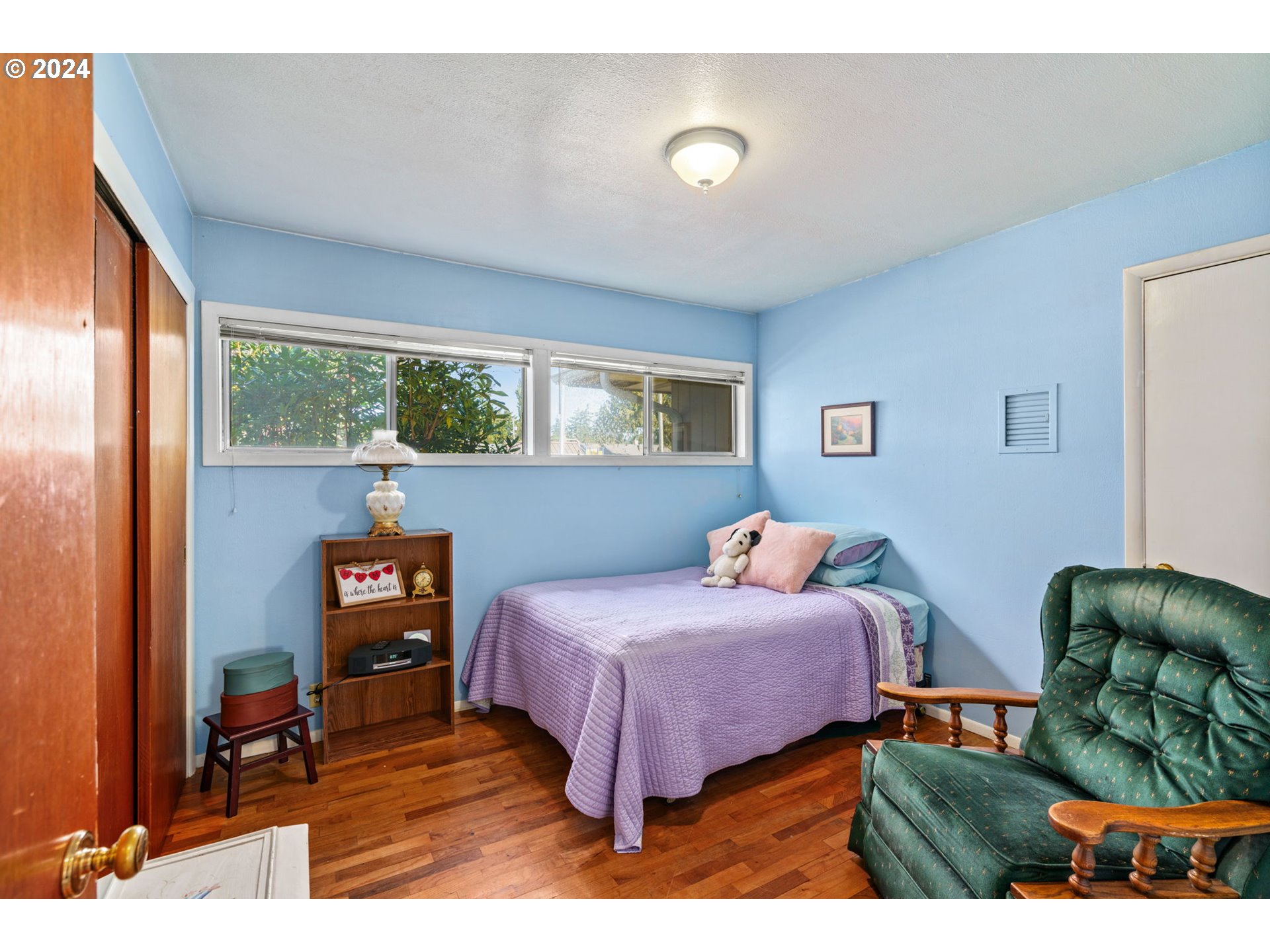 2290 18th Street Florence, OR 97439 - Photo 11 of 32 a bedroom with furniture and a large window