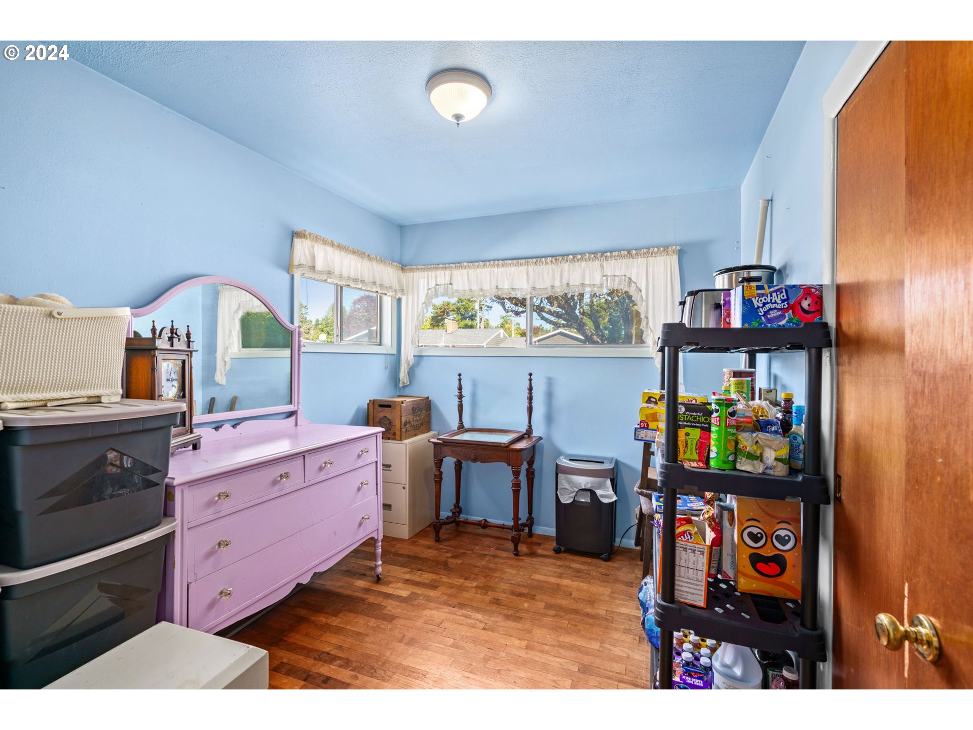 2290 18th Street Florence, OR 97439 - Photo 12 of 32 a bed room with a bed and a dresser