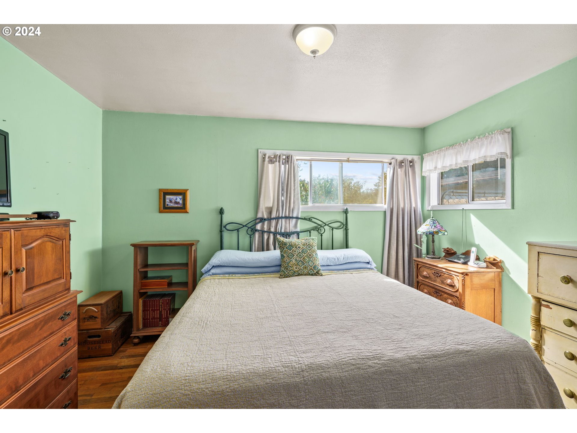 2290 18th Street Florence, OR 97439 - Photo 13 of 32 a bedroom with a bed and wooden floor