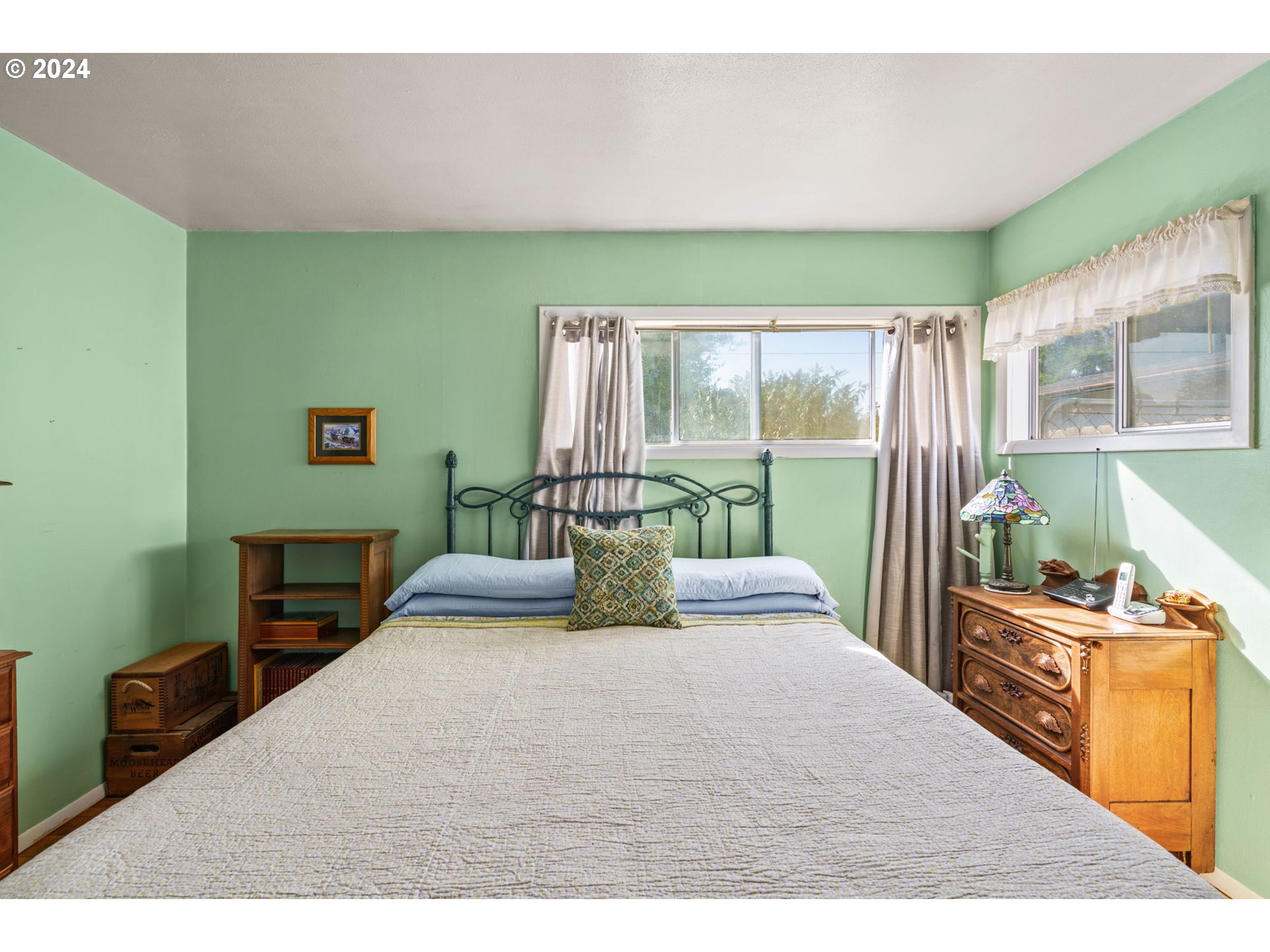 2290 18th Street Florence, OR 97439 - Photo 14 of 32 a bedroom with a bed window and a flat tv screen