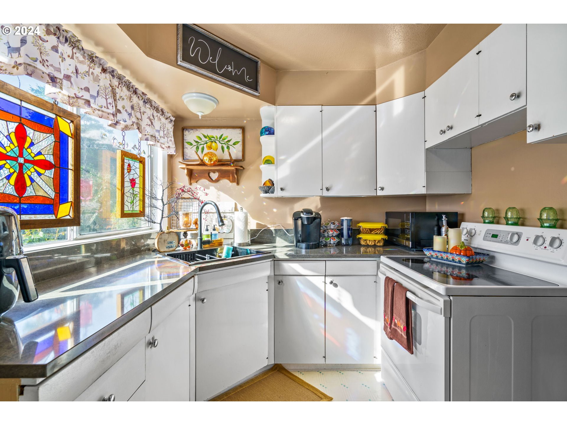2290 18th Street Florence, OR 97439 - Photo 20 of 32 a kitchen with stainless steel appliances granite countertop a sink and cabinets