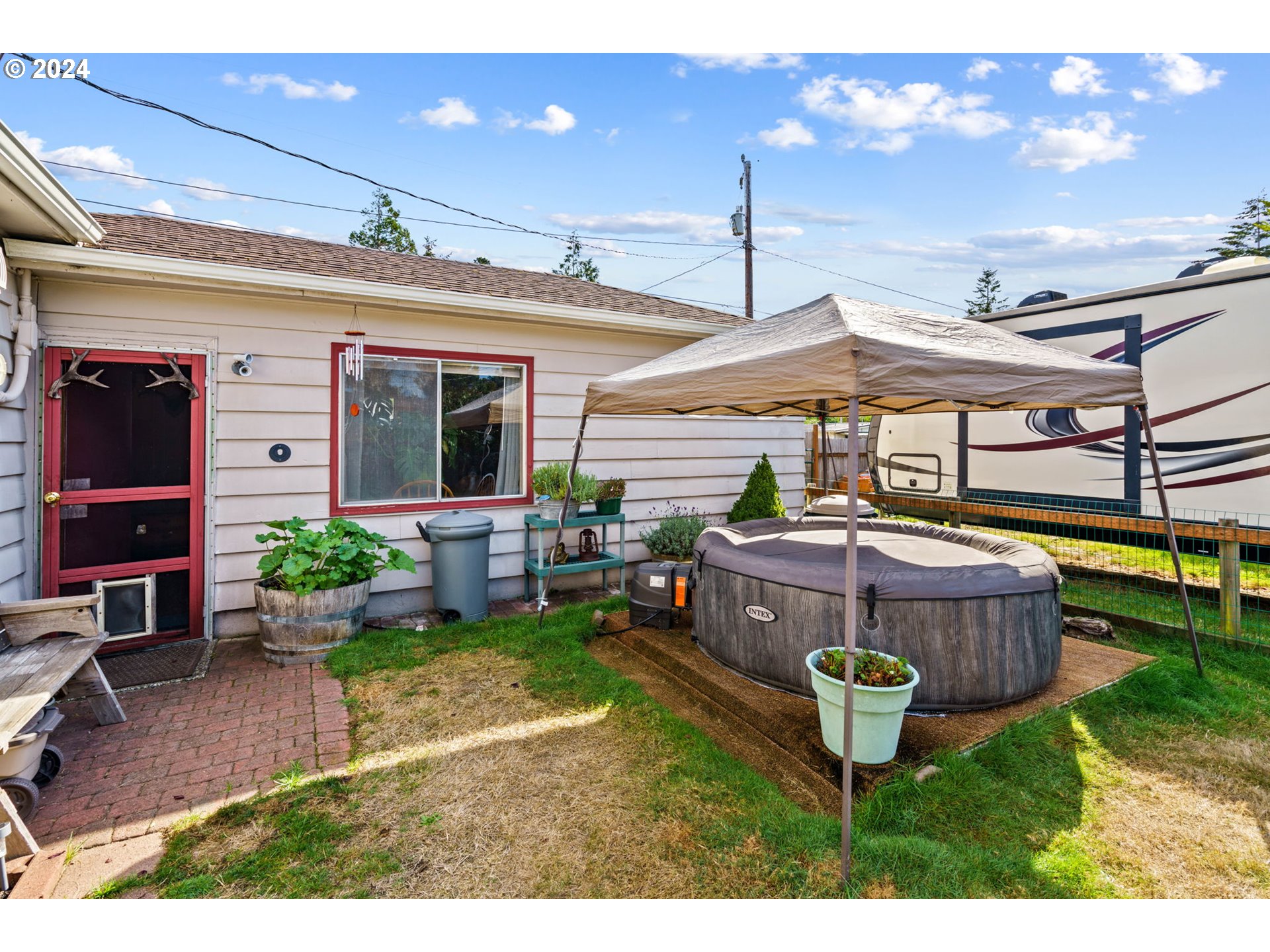 2290 18th Street Florence, OR 97439 - Photo 27 of 32 a view of a backyard with plants and patio