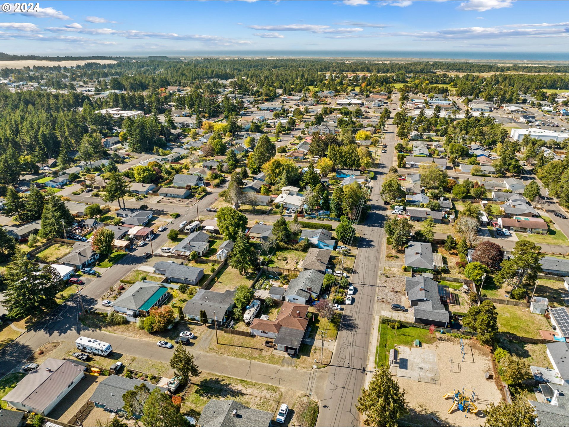 2290 18th Street Florence, OR 97439 - Photo 32 of 32 an aerial view of residential building and trees around