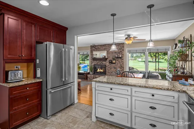 a kitchen with granite countertop cabinets and stainless steel appliances