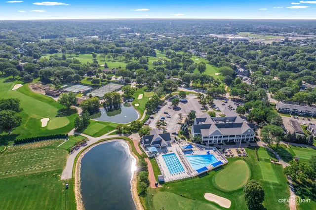 an aerial view of a house with a garden and lake view
