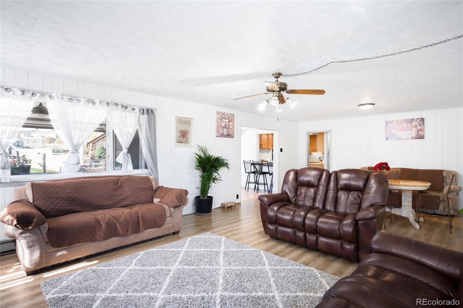 5354 Jackson Creek Road Sedalia, CO 80135 - Photo 11 of 47 a living room with furniture and a chandelier
