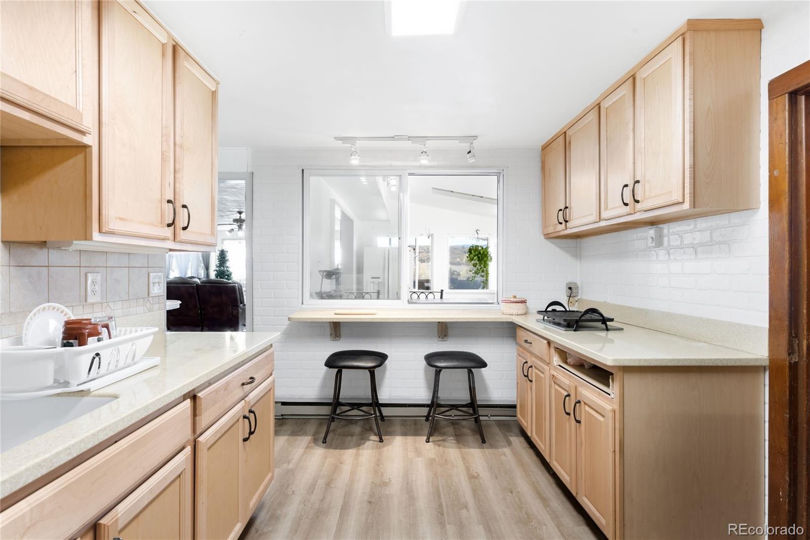 5354 Jackson Creek Road Sedalia, CO 80135 - Photo 13 of 47 a kitchen with stainless steel appliances granite countertop a sink stove and cabinets