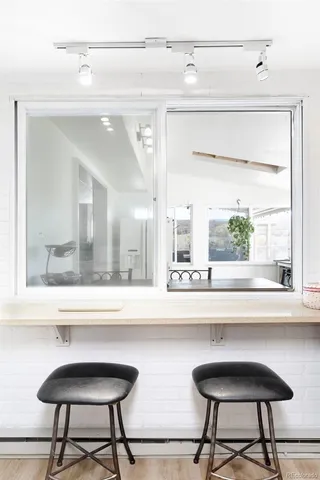 a bathroom with a mirror a sink and a window