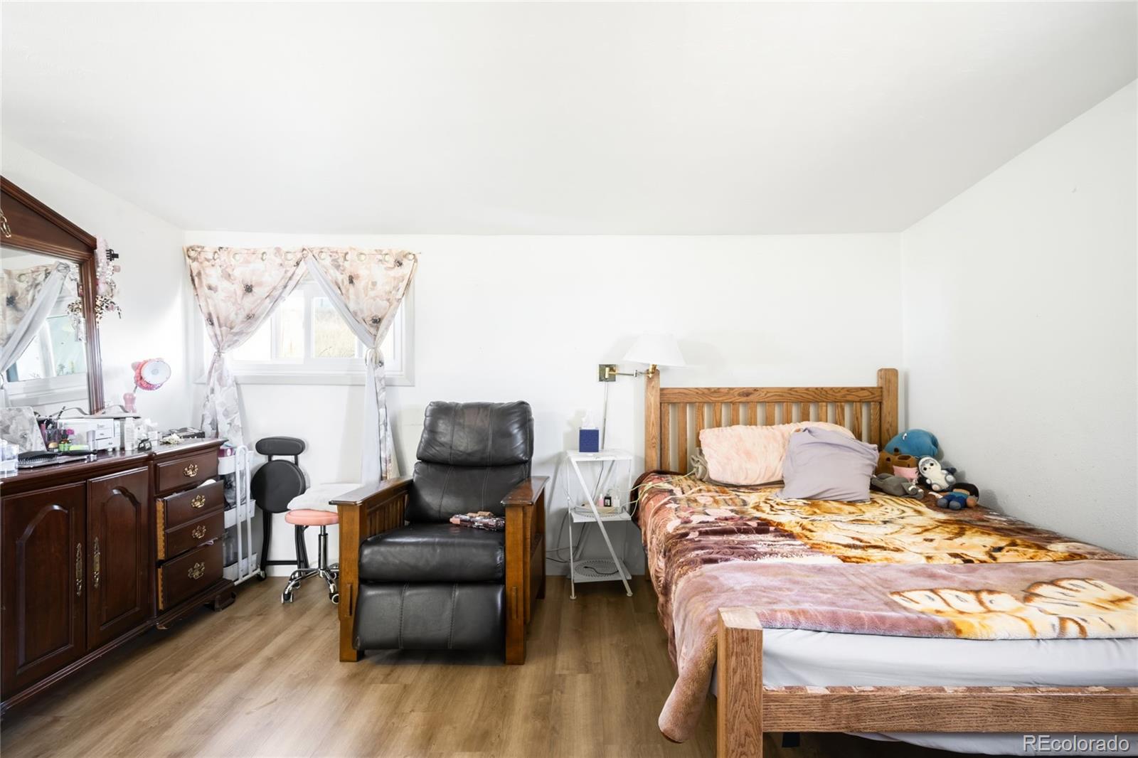 5354 Jackson Creek Road Sedalia, CO 80135 - Photo 15 of 47 a bedroom with a bed and a couch