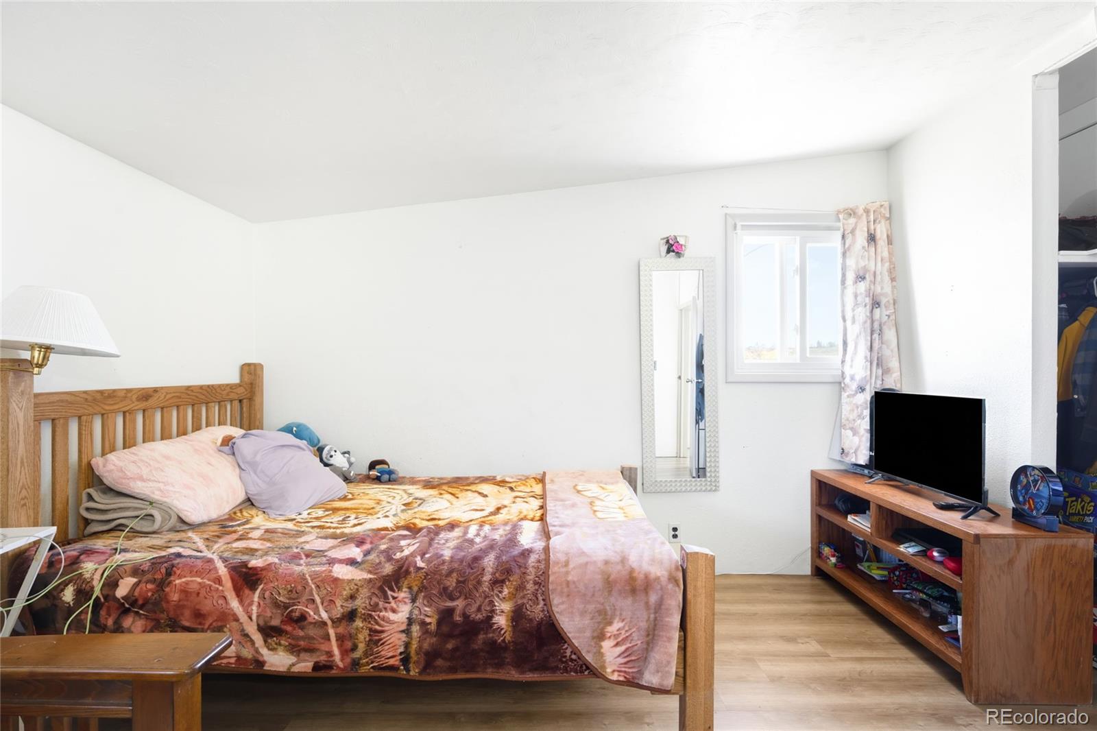 5354 Jackson Creek Road Sedalia, CO 80135 - Photo 16 of 47 a bedroom with a bed and flat screen tv