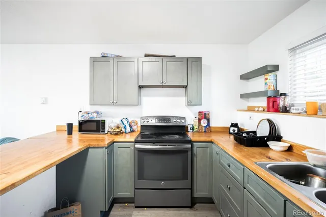 a kitchen with a sink stove and cabinets