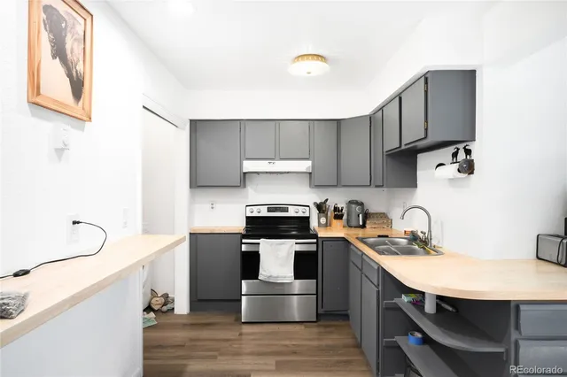 a kitchen with a sink appliances and cabinets
